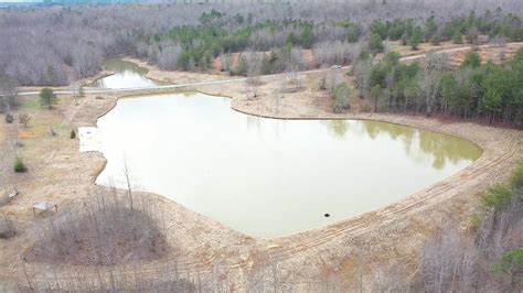 Shaping 1/4 acre pond with dozer. 5 Acre Pond Build A Year Later - YouTube