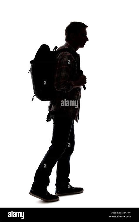 Silhouette Of A Male Tour Guide Hiking And Carrying A Backpack On A