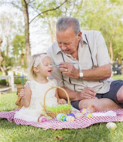 Loving Grandfather And Granddaughter Coloring Easter Eggs Together On Picnic Bla Photo12