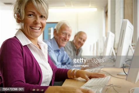 Mature Woman And Two Mature Men In Computing Class Portrait High Res