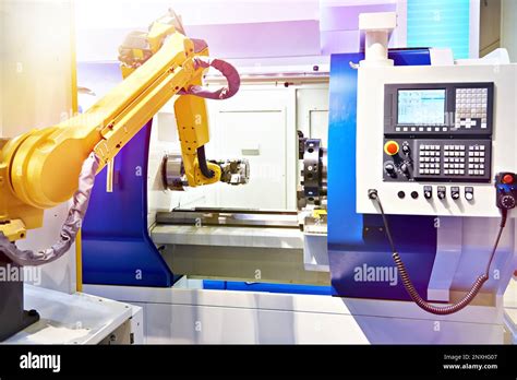 Robotic Arm And Cnc Lathe Machine Stock Photo Alamy