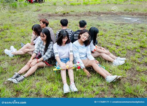 Men And Women Sitting On Grass Forming Circle Of Friends Picture Image 117689171