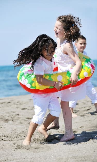 Premium Photo Happy Young People Group Have Fun Run And Jump On Beach