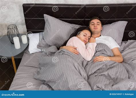 Portrait Of Attractive Young Couple Hugging Each Other While Sleeping In The Bed Stock Image