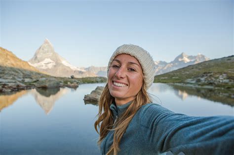 Woman Takes Selfie With The Matterhorn In Distance Stock Photo