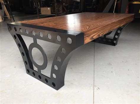 Featuring 2 end tables and a coffee table, this set offers a stylish industrial aesthetic by combining the look of rustic wood with steel. Industrial Coffee Table - Wildwood Metalworks