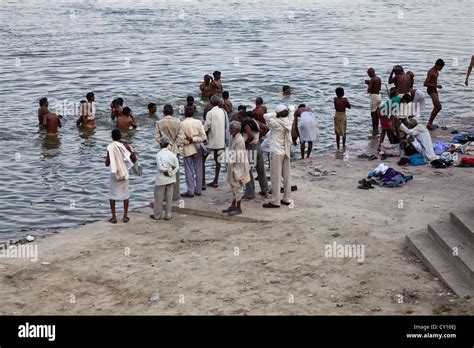 Taking A Bath In The Holy River Ganges In Varanasi India Stock Photo