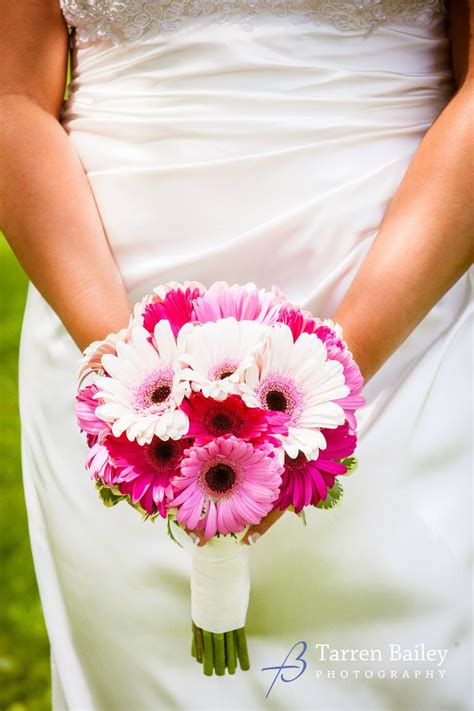 Designers may need to make substitutions in an effort to provide the highest quality product fresh and fabulous, this stylish blend of white daisies and pink roses in a fuchsia ginger jar will brighten any occasion. A clean and simple handtied wedding bouquet of only ...
