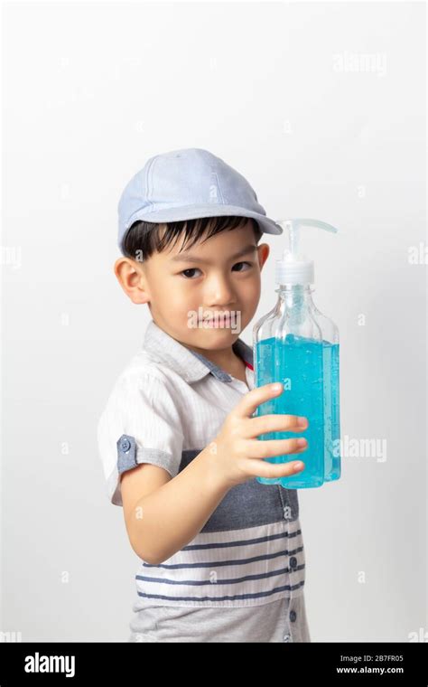 Asian Boy Holding Bottle Of Alcohol Gel For Cleaning Baby Hands To