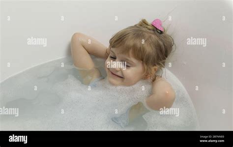 Attractive Four Years Old Girl Takes A Bath In Swimwear Hygiene For