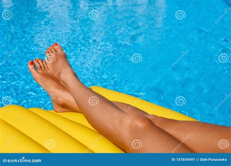 Portrait Of Beautiful Tanned Woman Relaxing In Bikini In Swimming Pool