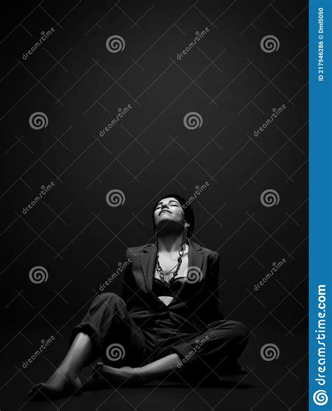 Pretty Short Haired Brunette Woman In Business Smart Casual Suit On Naked Body Sits On Floor