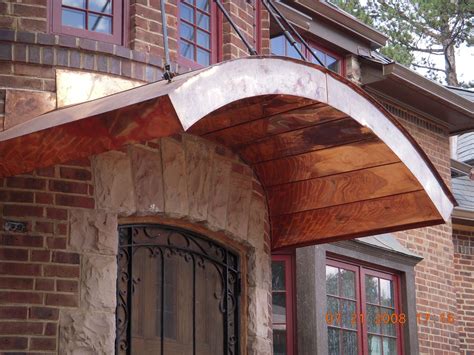 However, whilst many of the designs listed above do utilise wooden parts, they can also include glass and metal, which offer a completely different aesthetic. Arched flat seam door awning. Raleighroofing.com (With ...