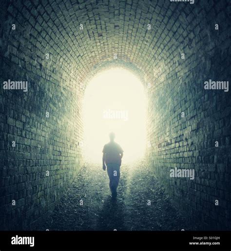 Boy Walking Through Tunnel Stock Photo Alamy