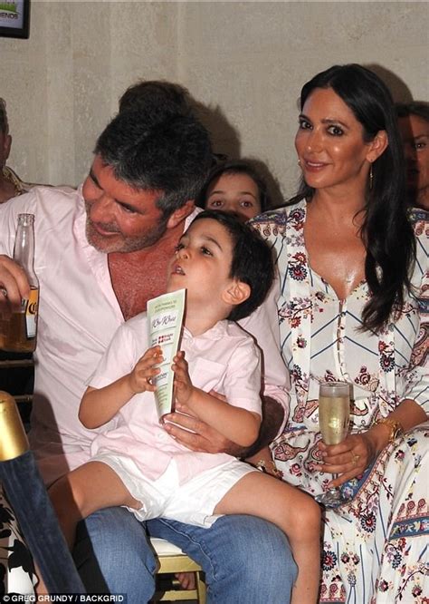 simon cowell cuddles son eric at charity gala in barbados