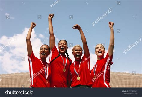 Professional Female Soccer Players Celebrating Victory Stock Photo