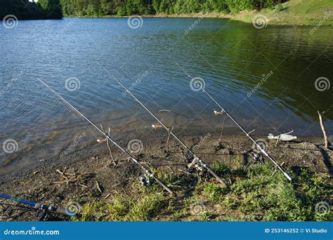 Fishing Rods And Fishing Tackle On The River Bank Beautiful Nature