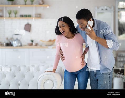 Pregnant African American Woman Having Prenatal Contractions Worried Husband Calling Doctor On
