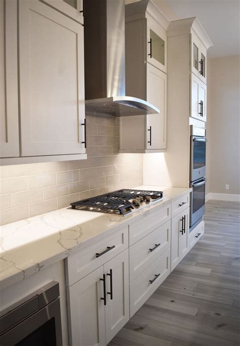 Getting white kitchen cabinets may seem like a white shaker cabinetry with black countertops and glass by south shore decorating. All White Custom Kitchen with Stainless Steel Appliances ...