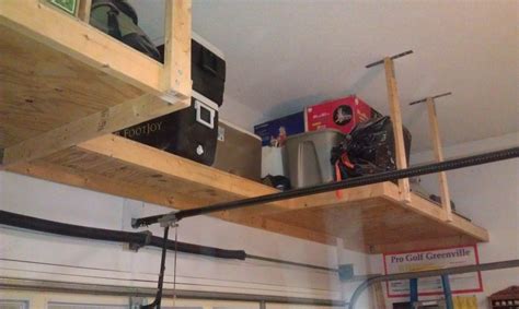 How about creating a suspended, sliding storage system where you could keep all your tools and other goodies? Above garage door storage - by VaprTral @ LumberJocks.com ...