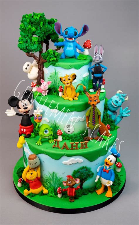 A Three Tiered Cake With Cartoon Characters On Its Sides And Trees In