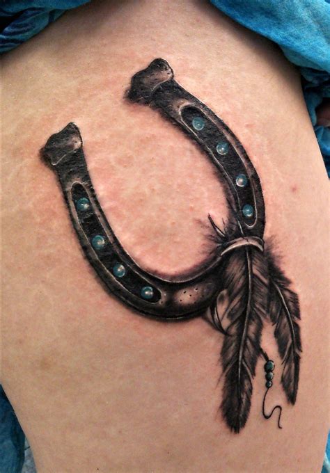Custom Horseshoe Tattoo With Feathers Thigh Tattoo By Dave In Syston