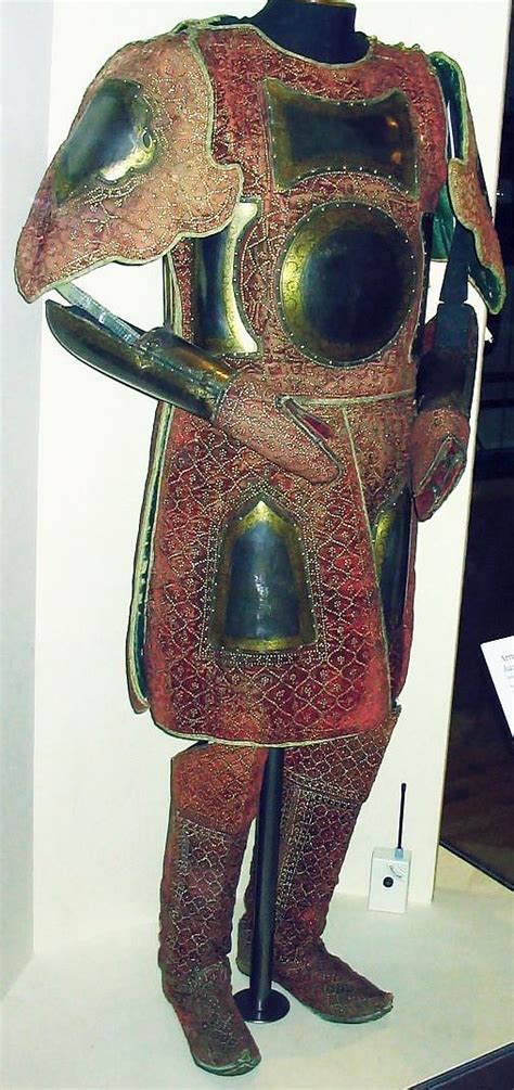 A Statue Of A Man In Armor Is On Display