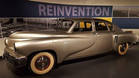 An Old Car Is On Display In A Museum With A Sign Above It That Says
