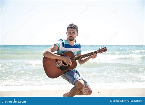 Young Man With Acoustic Guitar On The Beach Stock Photo Image Of