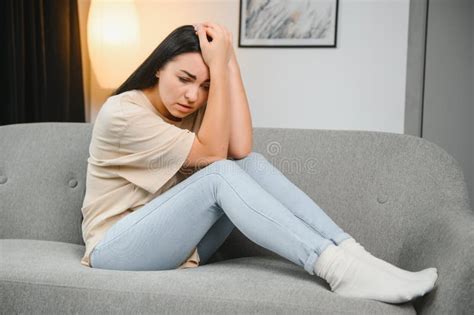 Depressed Sad Attractive Woman Crying On Sofa Couch At Home Feeling