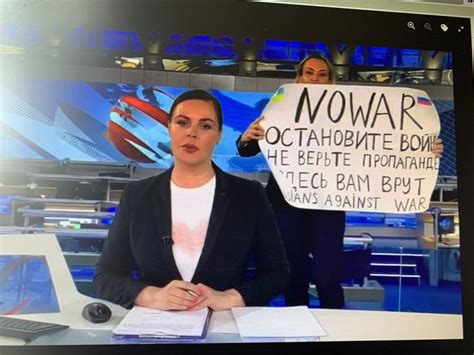 ukraine war woman interrupts russian tv news show live on air with no to war sign video
