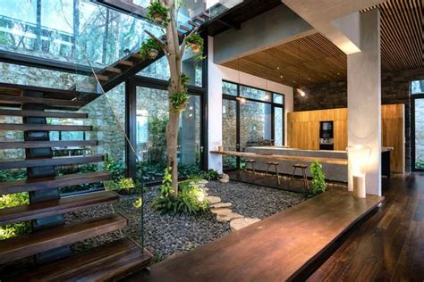 Indoor Courtyard Garden Surrounded With A Staircase That Leads To The