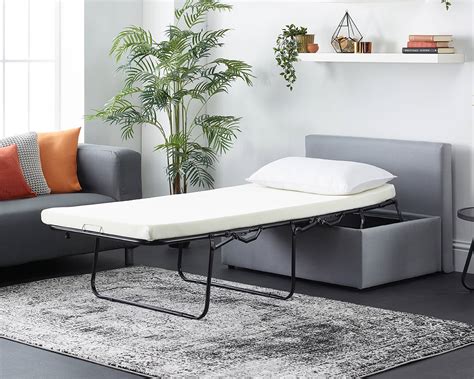 A bit of a squeeze for two, but a roomy option for a single guest. Footstool Sofa Bed - Foldaway Single Guest Bed with Mattress - Mail Shop in partnership with Aspire