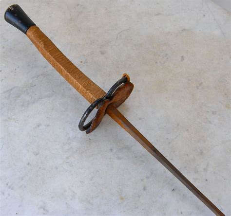 Fencing sword made of wood with a straight blade and a rounded tip. Sale Antique SOLINGEN FENCING FOIL or Sword 19th Century