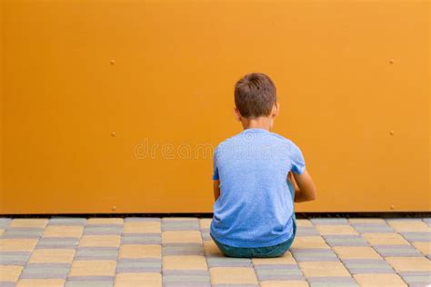 Sad Alone Boy Sitting Near Colorful Wall Outdoors Stock Photo Image