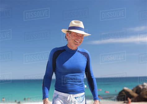 Smiling Caucasian Man Standing On Beach Stock Photo Dissolve