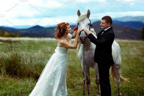 Bride And Groom Stroke A White Horse ~ People Images ~ Creative Market