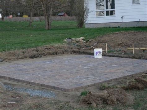 A pickax can help loosen up the soil, which will make it easier to start laying the concrete pavers within the stringed area. DIY Patio Installation - How to Build a Paver Patio ...