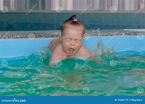 Little Girl Is Jumping Into Water In The Pool Stock Image Image Of