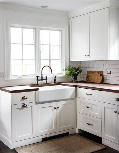 Cabinet hardware is often referred to as the jewelry of a kitchen, and just like with an outfit, it can really alter the overall look of your space. White Shaker Kitchen Cabinets with Wood Countertops and ...