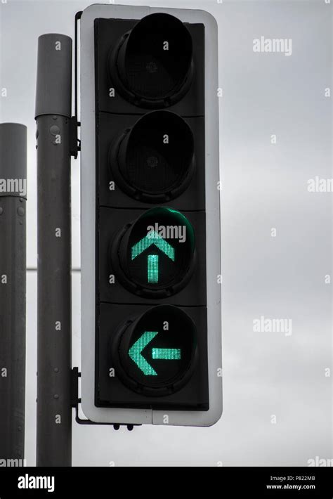 Traffic Lights On Green Turn Left Or Go Straight Ahead Uk Stock Photo