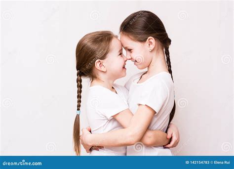 two girls sisters gently hug each other when meeting stock image image of cute domestic