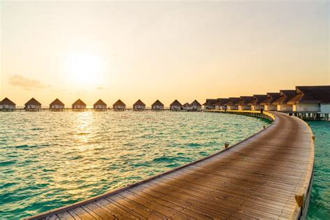 beautiful tropical sunset over maldives island with water bungalow in hotel resort stock image