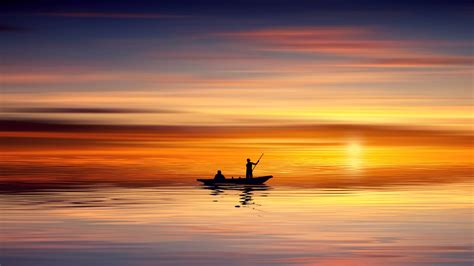 Download 2560 X 1440 Sea Fisherman During Sunrise Wallpaper
