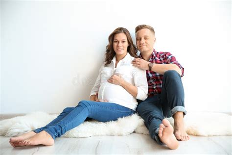 Pregnant Woman With Her Husband Near White Wall Stock Image Image Of Awaiting Adult 131008765