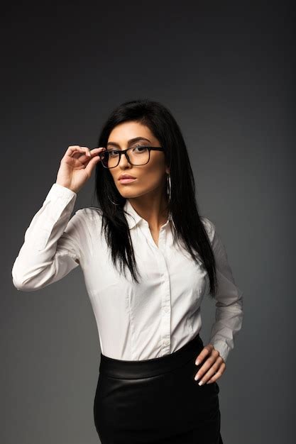 Premium Photo Sexy Brunette With Glasses In A White Blouse With A Black Leather Skirt