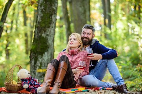 premium photo couple in love celebrate anniversary picnic date couple cuddling drinking wine