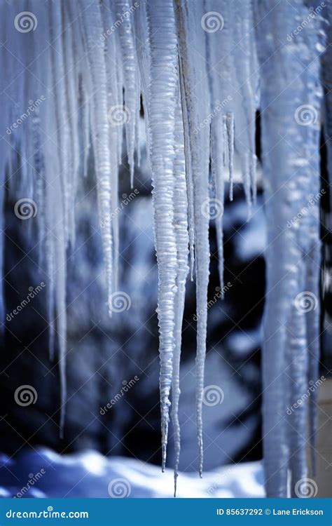 Icicles Hanging From Rooftop Of Home Melted Ice Dripping Stock Photo
