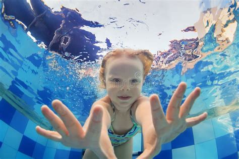 Funny Portrait Of Baby Girl Swimming Underwater In Pool Stock Image