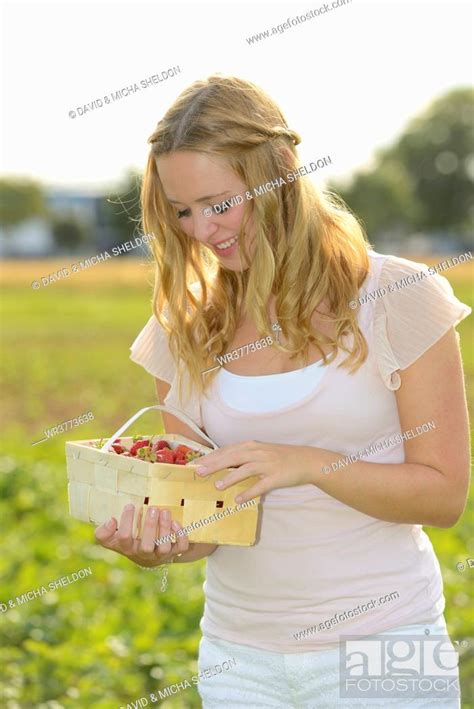 Teenage Girl With Strawberries In Field Stock Photo Picture And